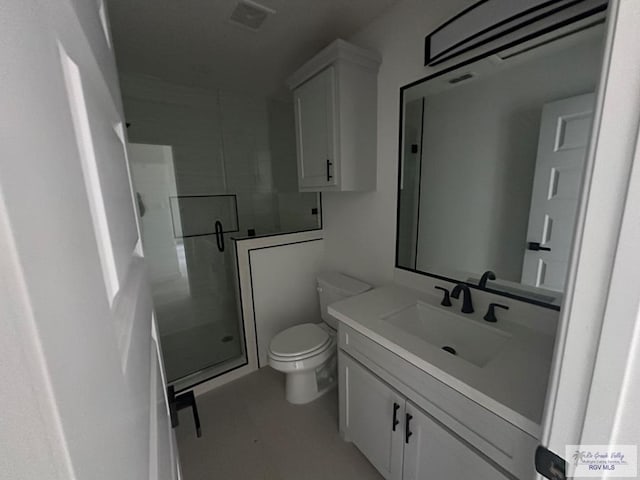 bathroom featuring toilet, vanity, and walk in shower