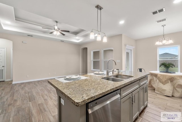 9725 Hawk Dr, Harlingen, TX 78552 - kitchen featuring dishwasher, open floor plan, a sink, arched walkways, and light wood finished floors