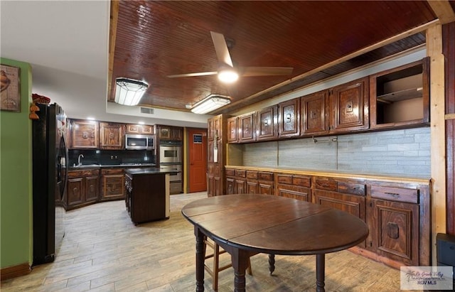 28880 Bass Blvd, Harlingen, TX 78552 - kitchen featuring stainless steel appliances, a center island, ceiling fan, wooden ceiling, and light wood-style flooring