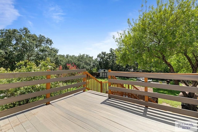 28880 Bass Blvd, Harlingen, TX 78552 - wooden deck featuring a shed and view of scattered trees
