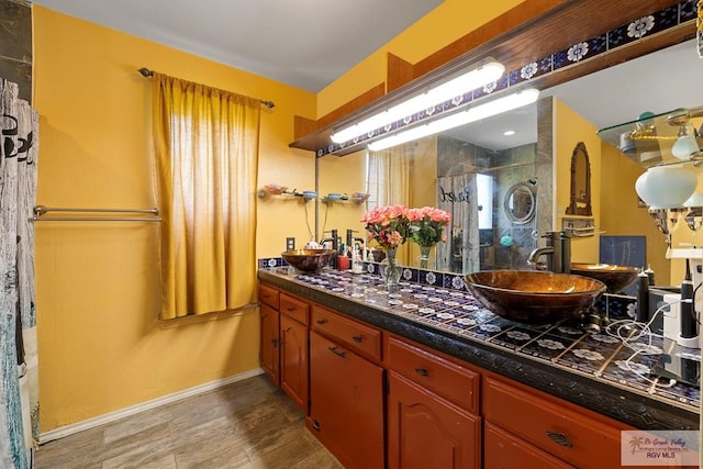 28880 Bass Blvd, Harlingen, TX 78552 - bathroom featuring vanity, a stall shower, and wood finished floors