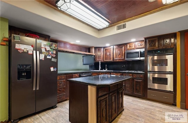 28880 Bass Blvd, Harlingen, TX 78552 - kitchen featuring stainless steel appliances, light wood-style flooring, a kitchen island, dark brown cabinets, and wooden ceiling