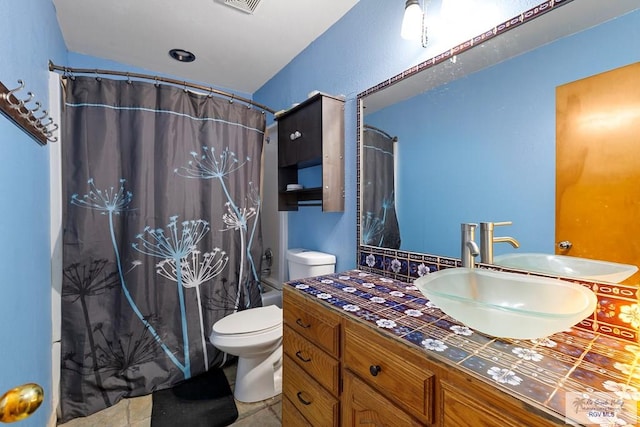 28880 Bass Blvd, Harlingen, TX 78552 - bathroom featuring vanity, shower / bathtub combination with curtain, and tile patterned flooring