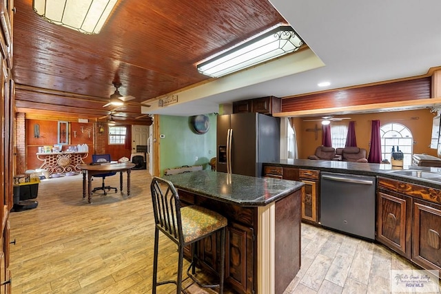 28880 Bass Blvd, Harlingen, TX 78552 - kitchen featuring appliances with stainless steel finishes, ceiling fan, light wood-style flooring, open floor plan, and a center island