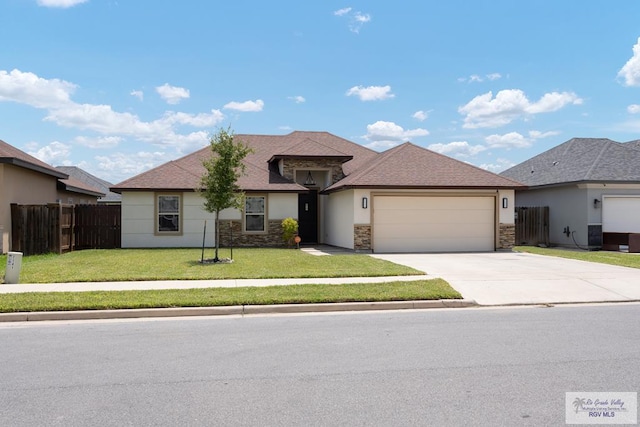 view of front of property with a garage and a front lawn