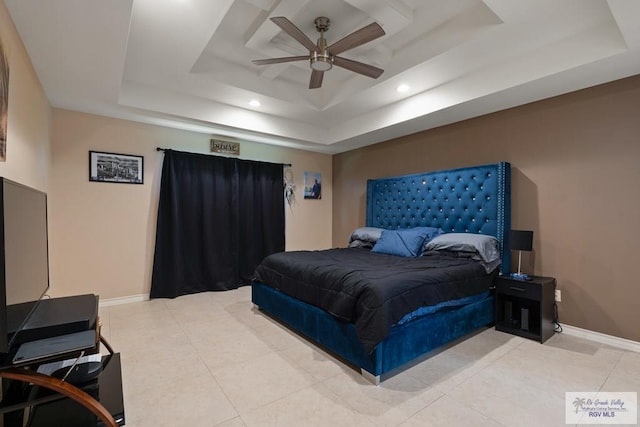 tiled bedroom featuring a raised ceiling and ceiling fan