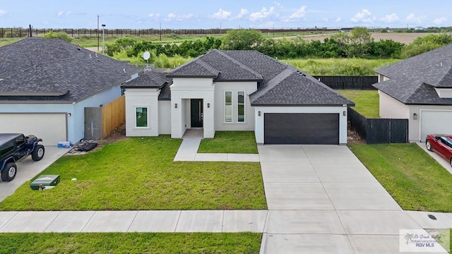 view of front of property with a garage and a front lawn