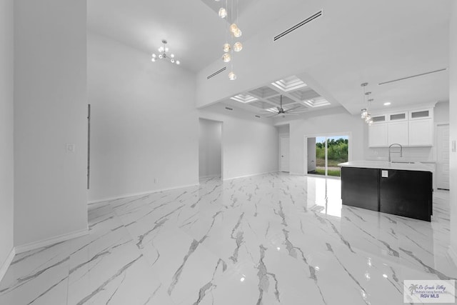 interior space with sink and ceiling fan with notable chandelier