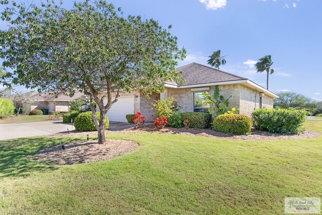 view of front of home featuring an attached garage, stone siding, concrete driveway, and a front yard