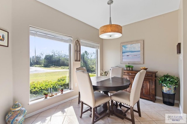 dining area featuring light tile patterned flooring and baseboards