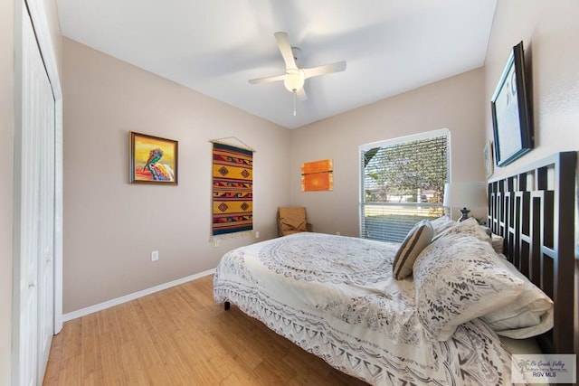 bedroom with baseboards, ceiling fan, and light wood-style floors