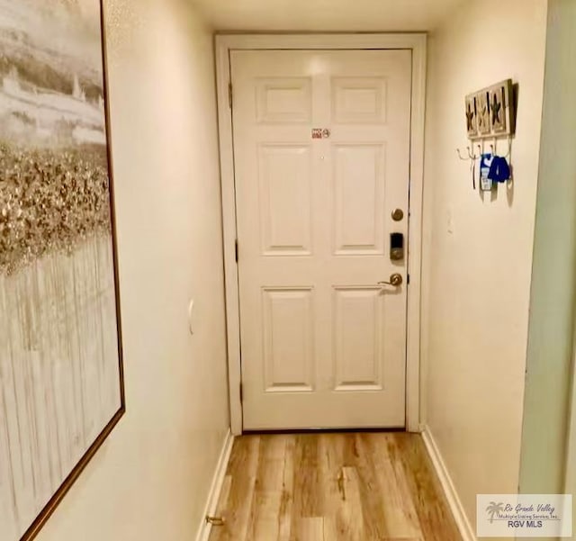 entryway featuring light wood-style floors and baseboards