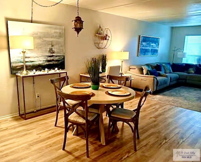 dining area with wood finished floors