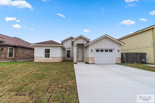 view of front of house featuring a garage and a front lawn