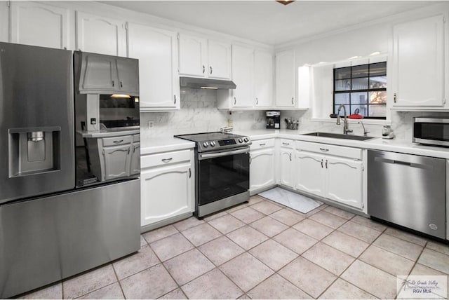 kitchen featuring under cabinet range hood, a sink, tasteful backsplash, stainless steel appliances, and light countertops