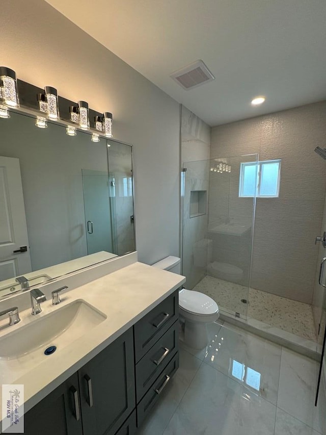 bathroom featuring an enclosed shower, vanity, and toilet