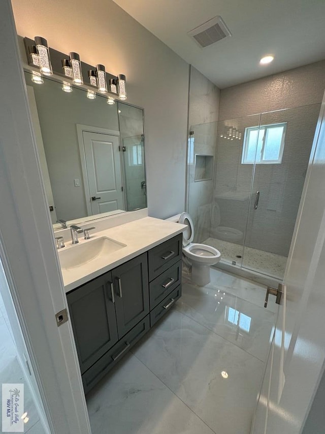 bathroom featuring toilet, vanity, and walk in shower