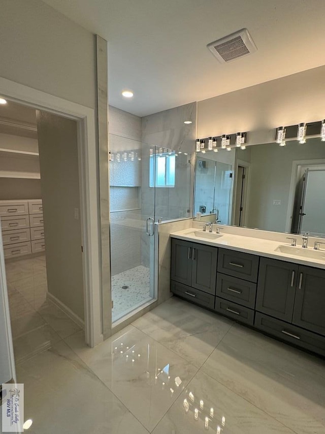 bathroom with vanity and a shower with shower door