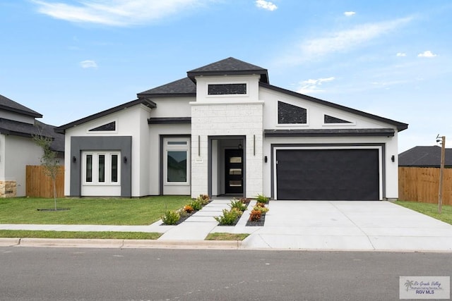 view of front of home featuring a front lawn and a garage