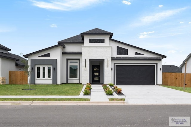 view of front facade featuring a front yard and a garage