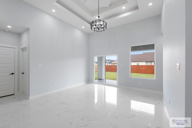 empty room with a notable chandelier and a towering ceiling