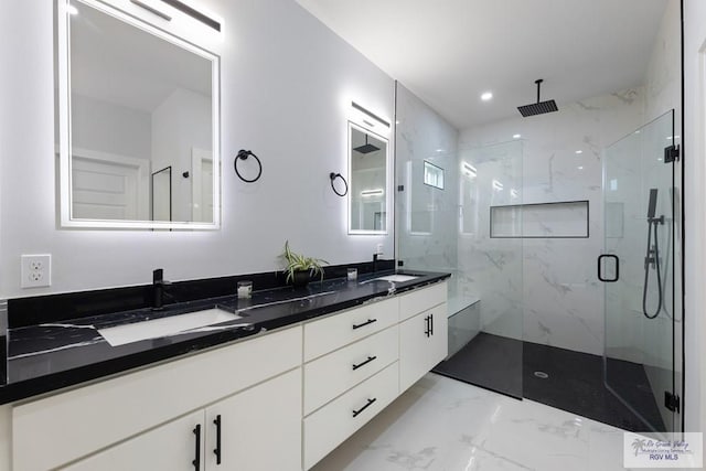 bathroom featuring vanity and an enclosed shower