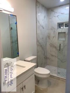 bathroom with vanity, toilet, and walk in shower