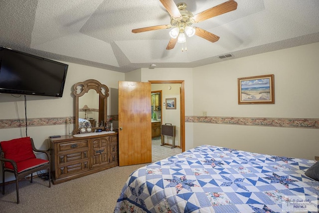 bedroom featuring light carpet, ceiling fan, a tray ceiling, lofted ceiling, and a textured ceiling