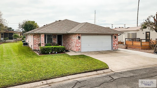 view of front of home with a front yard and a garage