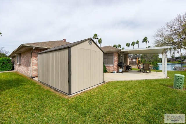 view of outdoor structure featuring a water view and a yard