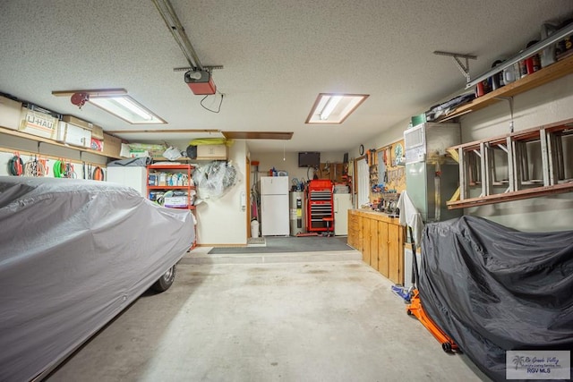 garage with fridge, a garage door opener, and a workshop area