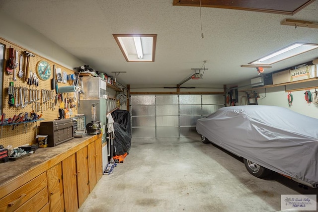 garage featuring a workshop area and a garage door opener