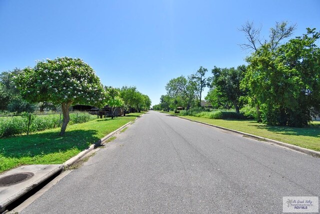 195 W 3rd St, Sebastian, TX 78594 - view of asphalt street featuring curbs