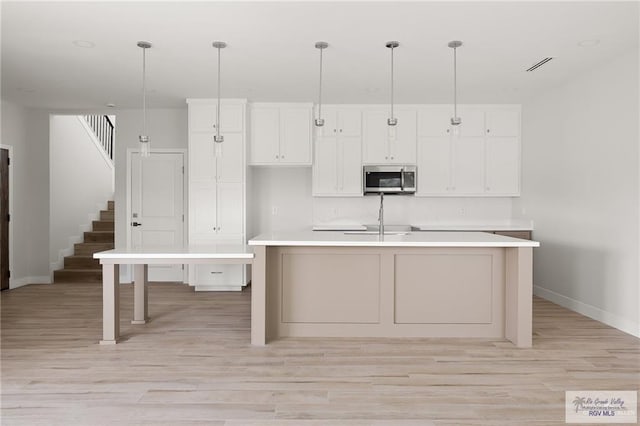2507 E Solar Dr Lot 45, Mission, TX 78501 - kitchen featuring pendant lighting, light hardwood / wood-style flooring, and a kitchen island with sink