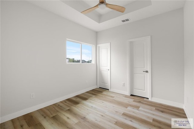 2507 E Solar Dr Lot 45, Mission, TX 78501 - unfurnished bedroom featuring a raised ceiling, ceiling fan, and light hardwood / wood-style flooring