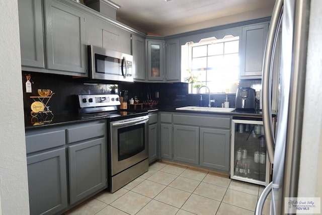 448 Rey Juan Carlos St, Brownsville, TX 78521 - kitchen featuring stainless steel appliances, a sink, gray cabinetry, and light tile patterned floors