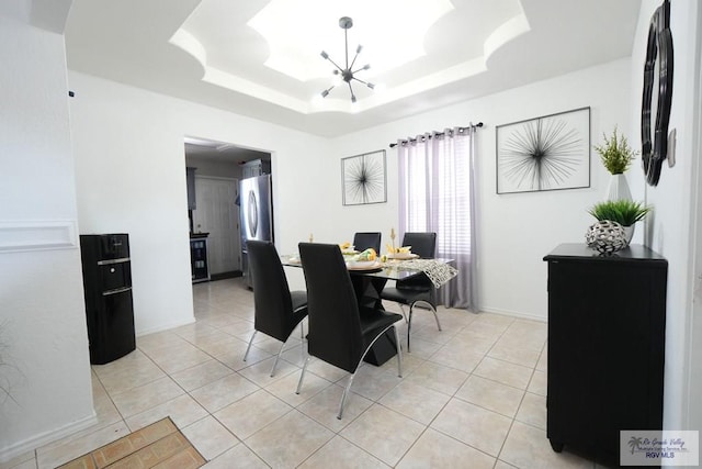 448 Rey Juan Carlos St, Brownsville, TX 78521 - dining space featuring a chandelier, a tray ceiling, light tile patterned flooring, and baseboards