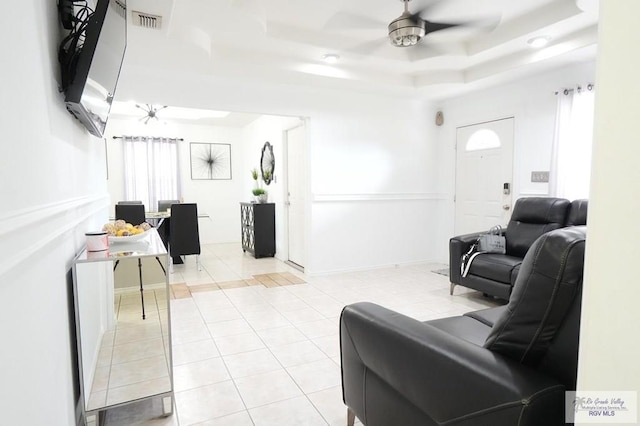 448 Rey Juan Carlos St, Brownsville, TX 78521 - living room with a tray ceiling, light tile patterned flooring, and a ceiling fan