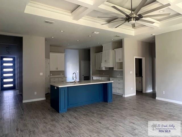 9206 Empress Ln, Harlingen, TX 78552 - kitchen with coffered ceiling, a sink, wood finished floors, white cabinetry, and baseboards