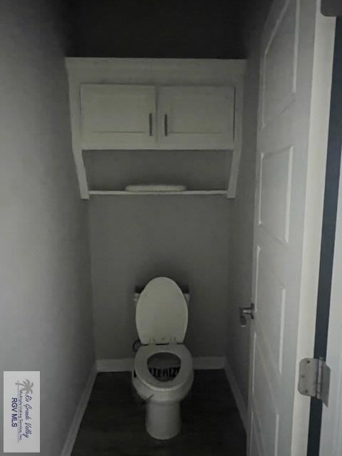 9206 Empress Ln, Harlingen, TX 78552 - bathroom featuring toilet and baseboards
