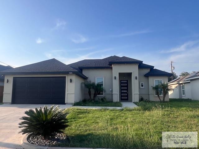 9206 Empress Ln, Harlingen, TX 78552 - prairie-style house with an attached garage, driveway, stucco siding, and a front lawn