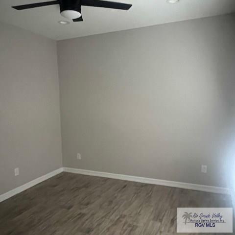9206 Empress Ln, Harlingen, TX 78552 - spare room featuring a ceiling fan, dark wood finished floors, and baseboards