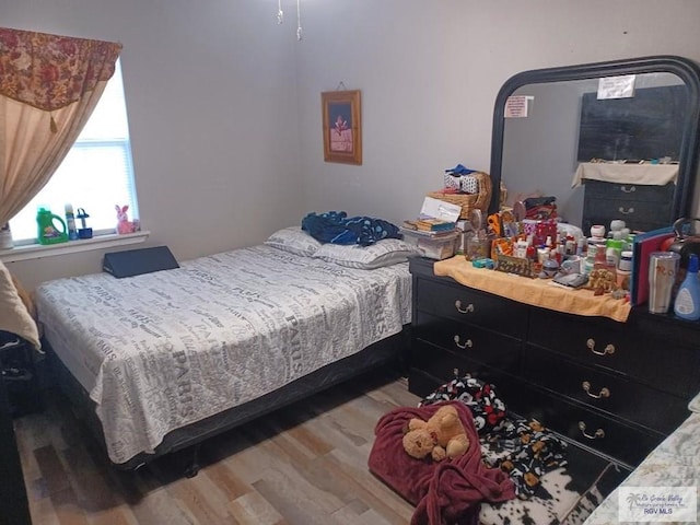 bedroom with hardwood / wood-style floors