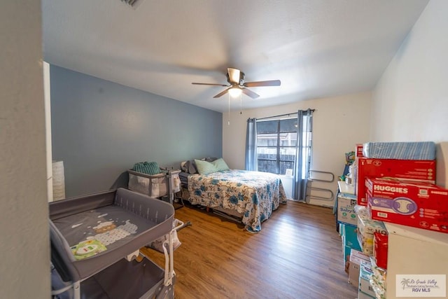 bedroom with ceiling fan and hardwood / wood-style floors