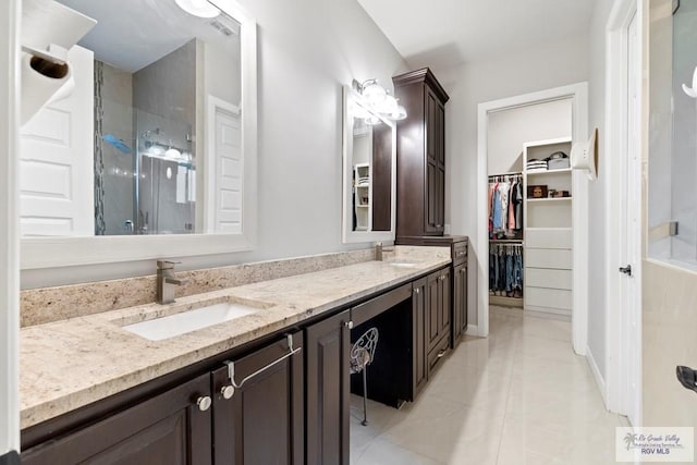 bathroom featuring tile patterned floors, vanity, and walk in shower