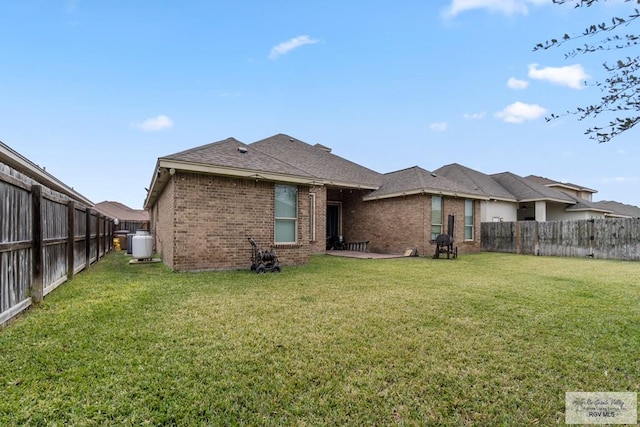 rear view of house featuring a yard