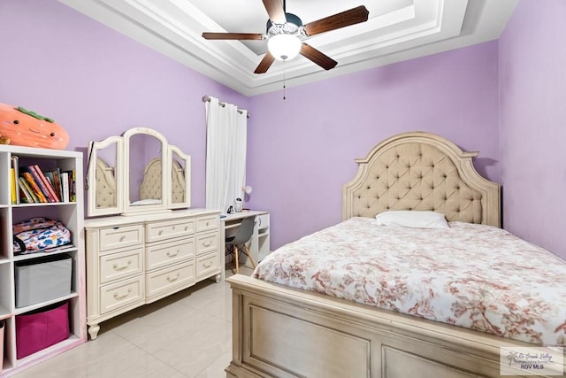 bedroom featuring a raised ceiling and ceiling fan