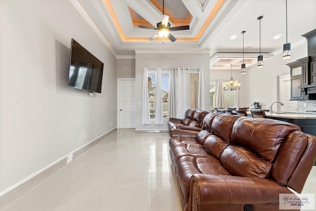 living room with ceiling fan with notable chandelier, a raised ceiling, ornamental molding, and sink