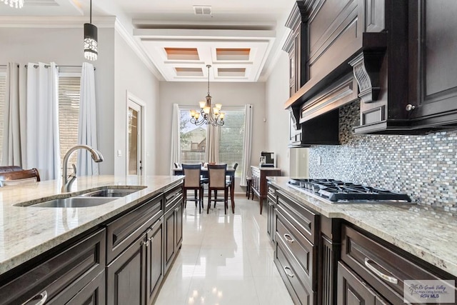 kitchen featuring pendant lighting, an inviting chandelier, stainless steel gas cooktop, and sink