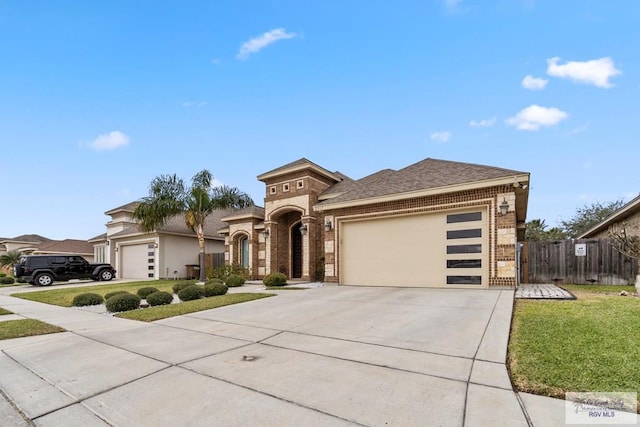 view of front of house featuring a garage and a front lawn